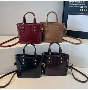 Détail de quatre sacs seaux rétro en cuir brillant bordeaux, marron, noir et café