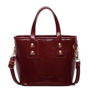 Polished burgundy patent leather bucket bag with top handle and adjustable strap