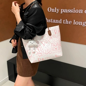 White tote bag with pink graffiti print and brown shoulder strap for women