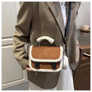 Close-up of lamb wool patchwork on the brown crossbody bag with mini plush charm