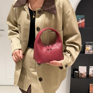 Minimalist wine red half-moon handbag in matte leather with vertical stitching detail