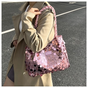 Close-up of pink sequin tote bag with woven handle and Fashion & Bags leather label