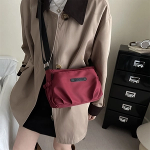 Dark red lightweight nylon crossbody bag for women with pleated sides and adjustable strap