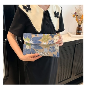 Detailed embroidery and sequins on floral crossbody clutch bag with bohemian patterns