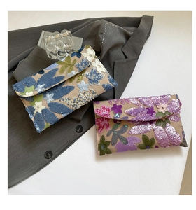 Detailed macro of two sequin embroidered handmade envelope clutches for evening banquets