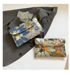 Detailed embroidery and sequins on elegant floral envelope clutch bags for evening events