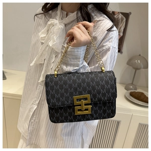 Detail view of vintage M-print crossbody bag with chunky gold chain and metal buckle