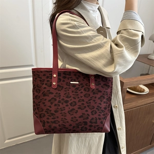 Minimalist burgundy leopard print tote bag for women shown on model in a 45-degree side view