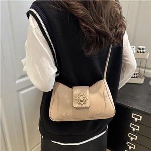 Elegant beige vintage underarm bag with intricate gold filigree buckle for women