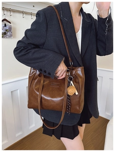 Brown vintage faux leather tote bag with fashion tag and cute bear charm detail