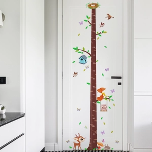 Detailed forest height chart sticker with cartoon fox and owl on a white door