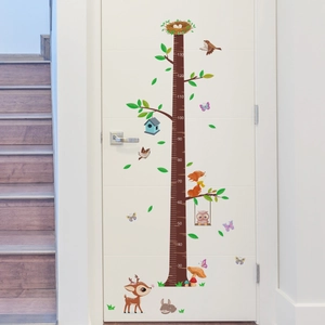 Detailed view of forest animals height chart sticker featuring deer and fox on a white door