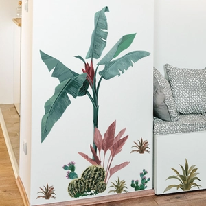 Detail view of tropical green plant wall stickers on a white modern living room wall