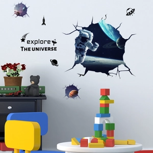 Detail of 3D astronaut wall sticker with planets and Explore the Universe text in kids room