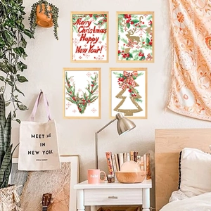 Detail view of four Nordic Christmas wall art prints featuring reindeer and pine tree designs