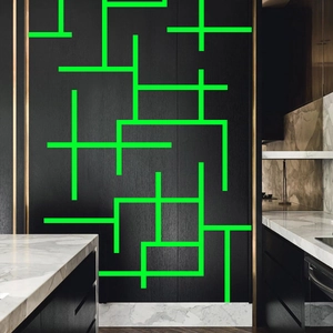 Glow-in-the-dark luminous safety tape with green geometric lines for stairs and walls