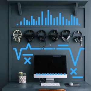 Overhead view of six modern over-ear headphones displayed above a desktop computer setup