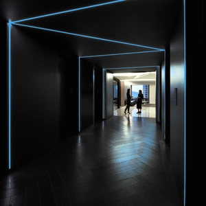 Modern office corridor featuring luminous blue LED strip lights with seamless glow effect