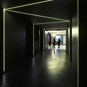 Luminous fluorescent tape installed on staircase corners showing bright geometric lines