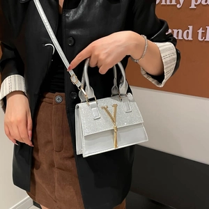 Mini bolso bandolera plateado con solapa de lentejuelas y logo V metálico con flecos
