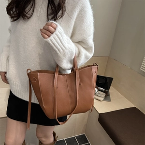 Brown litchi grain tote bag with white contrast stitching for casual daily commuting