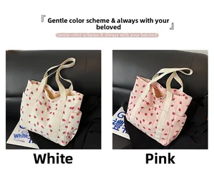 Detail view of pink and white corduroy tote bags with strawberry print and side pockets