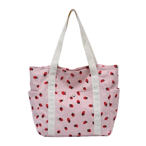 Pink corduroy strawberry tote bag with large capacity and white handles for commuting