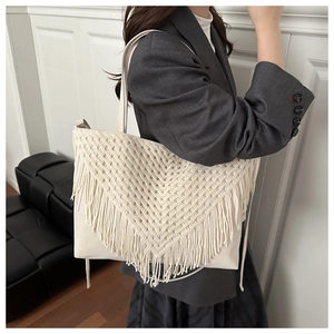 Detail of cream tote bag with bohemian geometric macrame fringe and leather texture