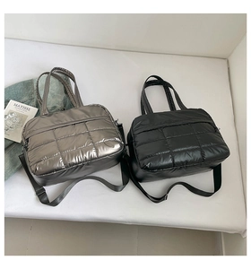 Quilted puffer tote bags in black and silver featuring detachable shoulder straps