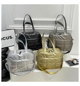 Detailed grid display of four metallic quilted puffer bags in silver gold black and grey