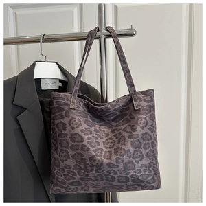 Detail of leopard print tote bag showing thick canvas texture and durable dual handles