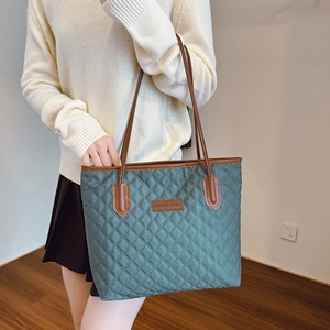 Quilted nylon tote bag with leather handles in dark green for women's daily commute