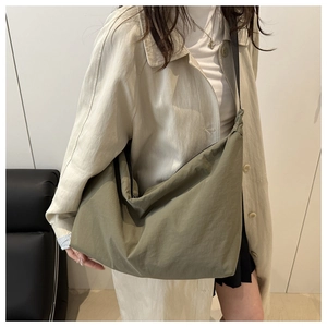 Detail of army green large nylon tote bag with adjustable strap for daily use