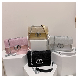 Detail view of stylish crossbody bags in four colors with glitter flap and metal ring clasp