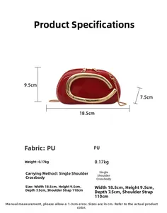 Macro shot of red PU leather bag with C-shaped gold buckle and delicate chain strap