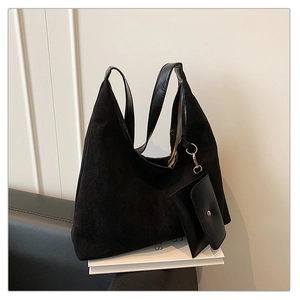 Detail of matte black tote bag with suede texture and matching small inner pouch