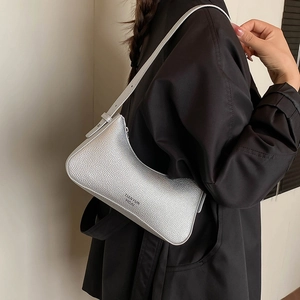 Silver lychee grain hobo bag worn by model with minimalist modern style design