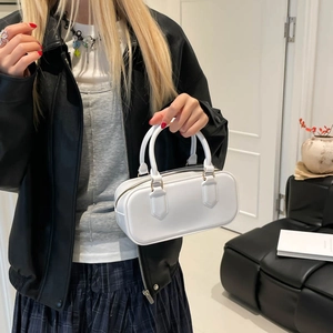 Minimalist white rectangular jelly bag with dual handles and golden hardware shown on model