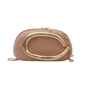 Elegant nude shoulder bag with large gold C-shaped metal handle and chain strap