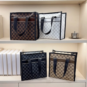 Set of four large printed tote bags with geometric M patterns and top handles