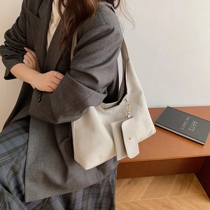 Minimalist beige matte large tote bag with chain pouch shown on a model for daily commute