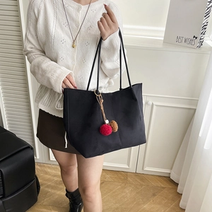 Elegant black large capacity tote bag with fuzzy pom-pom charm for autumn urban style