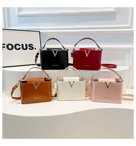 Row of crocodile pattern V-shaped handbags in five colors with golden metallic accents