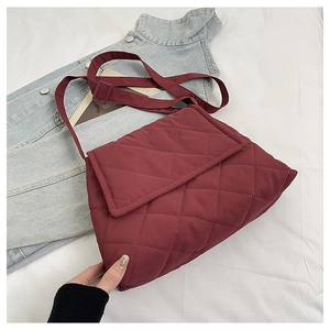 Burgundy quilted nylon crossbody bag shown from a 45-degree angle on a white fabric