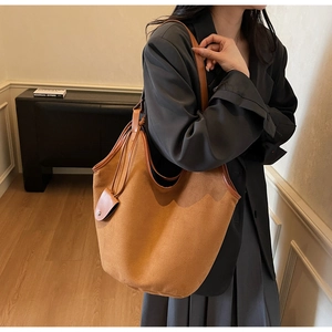 Caramel suede tote bag detail featuring large capacity and matching tassel coin purse charm