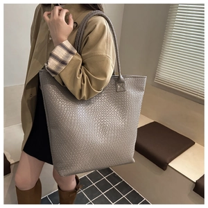 Detailed view of grey woven texture and large capacity structure on the tote bag