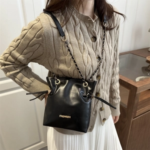 Premium black drawstring bucket bag with gold chain strap and fashion logo for women