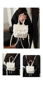 Detail view of mini cream backpack with ballet-style lace trim and decorative bow