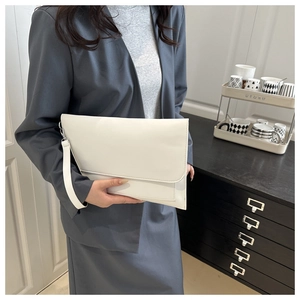 White minimalist envelope clutch bag held by model in a professional business setting