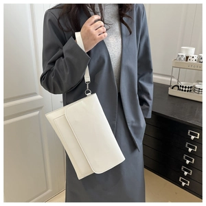 Detail of white rectangle clutch bag with wrist strap and silver metal buckle for women